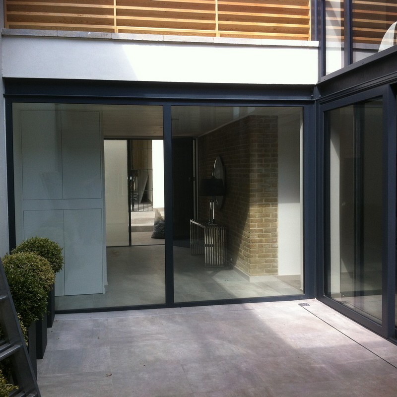 Floor-to-ceiling sliding doors opening to courtyard in Newport Pagnell