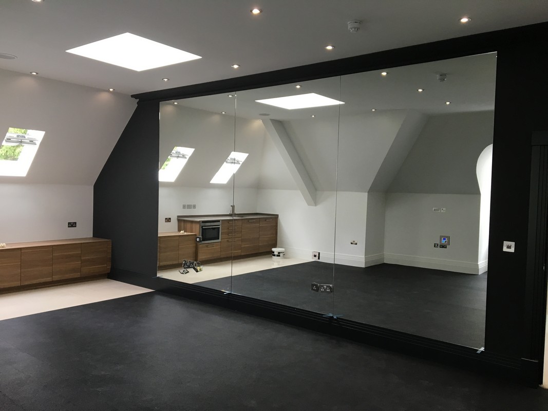 Frameless glass wall dividing loft conversion in Newport Pagnell